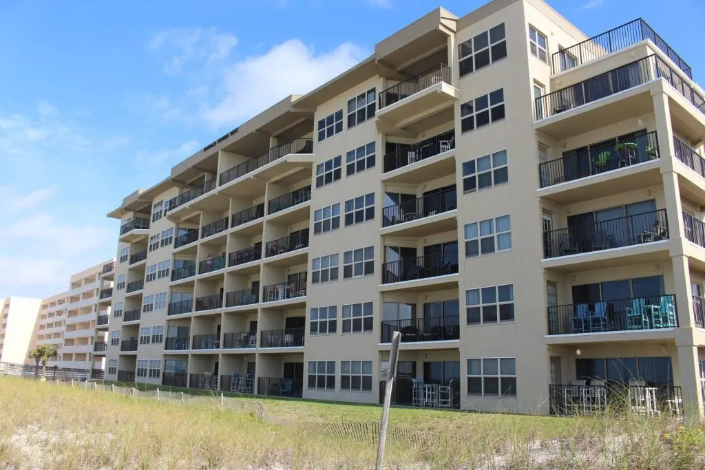 Stacked balconies and walkway rails along the Emerald Towers West elevation, Fort Walton Beach, Florida.